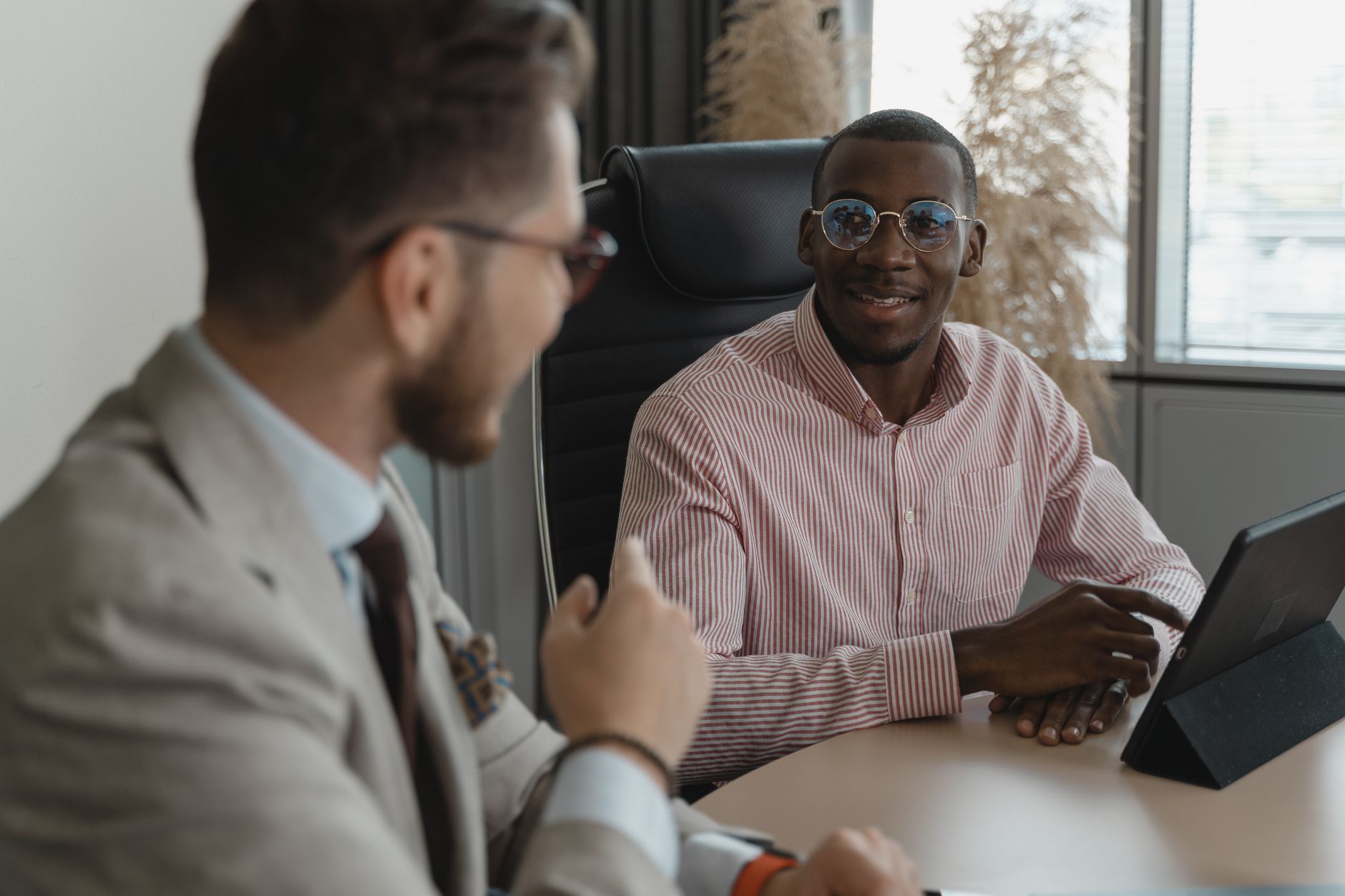 Diverse software engineer in a modern interview with a recruiter, conveying AI-assisted hiring